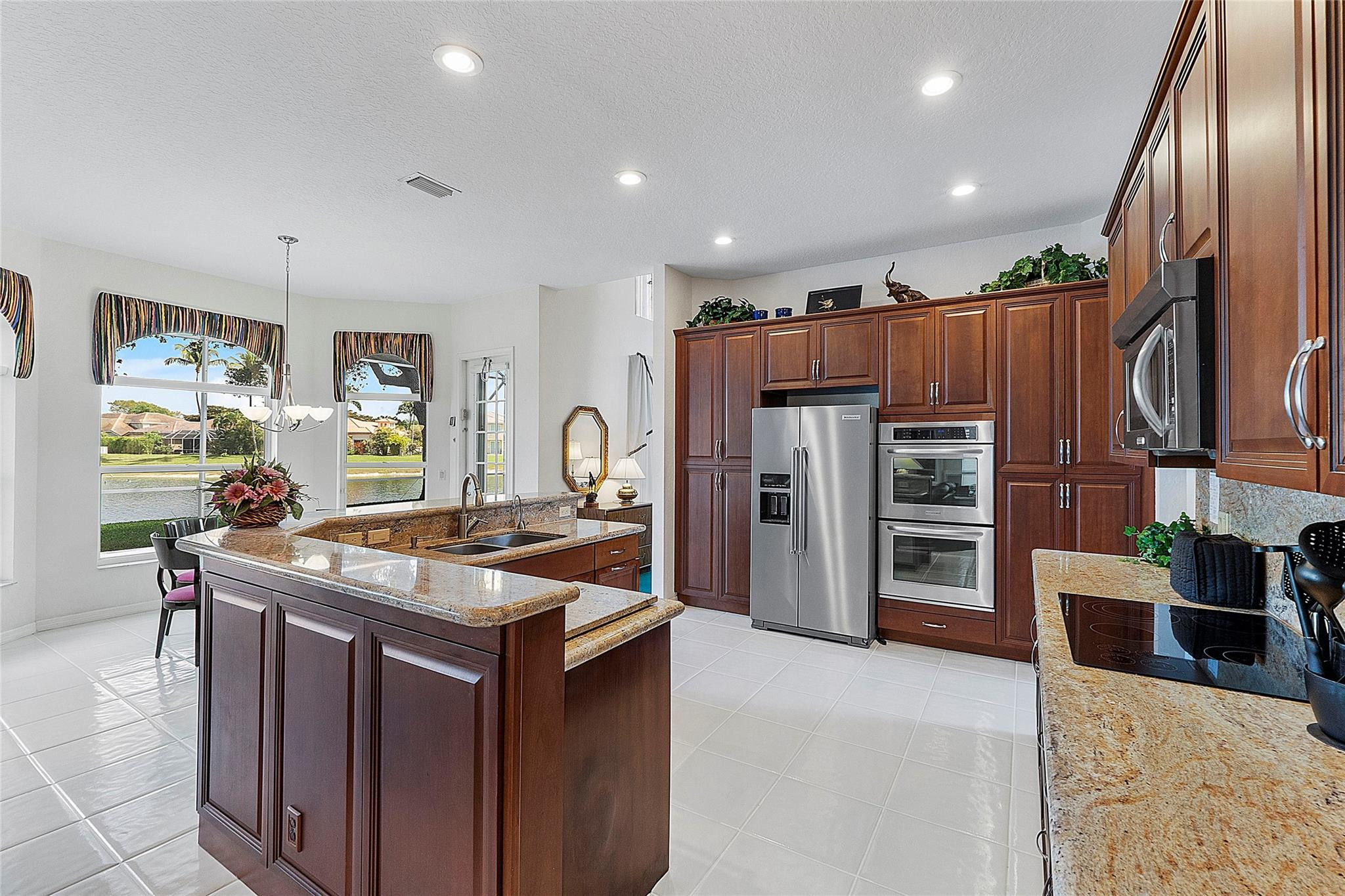 22293 Rushmore Place Boca Raton, FL 33428 - Photo 13 of 59 a kitchen with stainless steel appliances granite countertop a refrigerator and a stove top oven