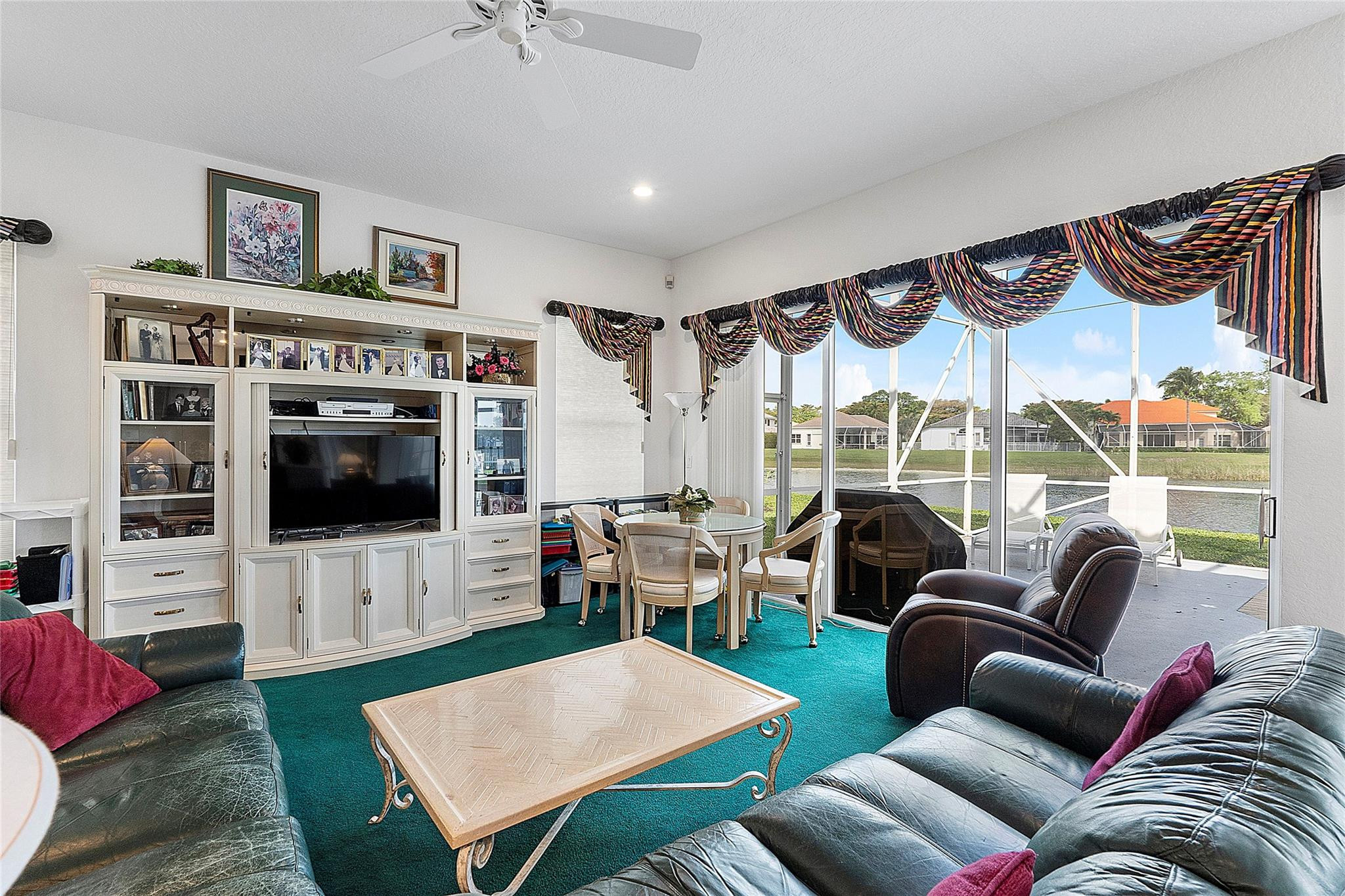 22293 Rushmore Place Boca Raton, FL 33428 - Photo 20 of 59 a living room with furniture a flat screen tv and a floor to ceiling window