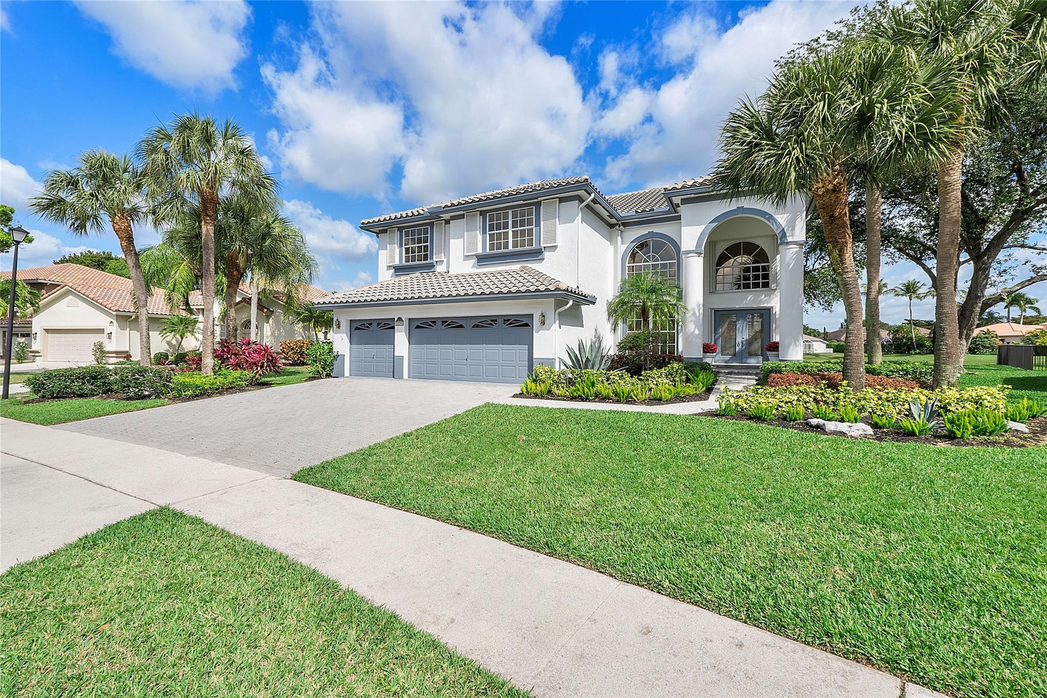 22293 Rushmore Place Boca Raton, FL 33428 - Photo 3 of 59 a front view of a house with a yard and garage