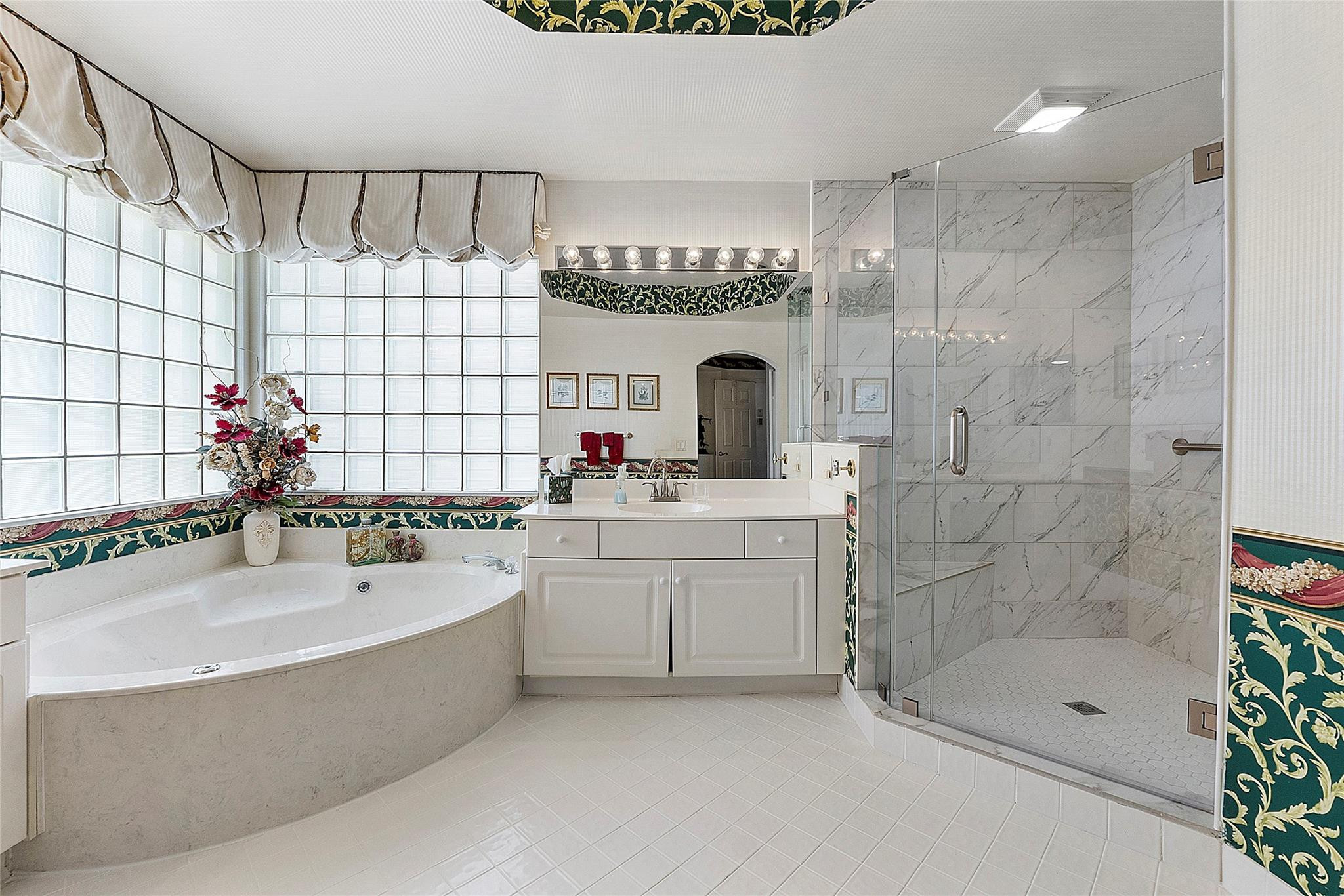 22293 Rushmore Place Boca Raton, FL 33428 - Photo 35 of 59 a bathroom with a tub sink mirror and shower