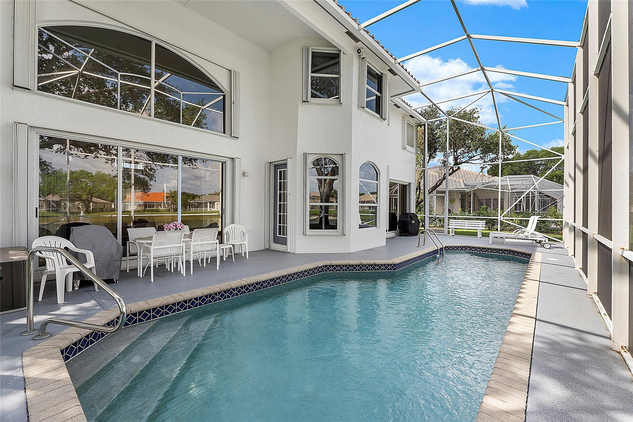 22293 Rushmore Place Boca Raton, FL 33428 - Photo 40 of 59 a view of a swimming pool with outdoor seating