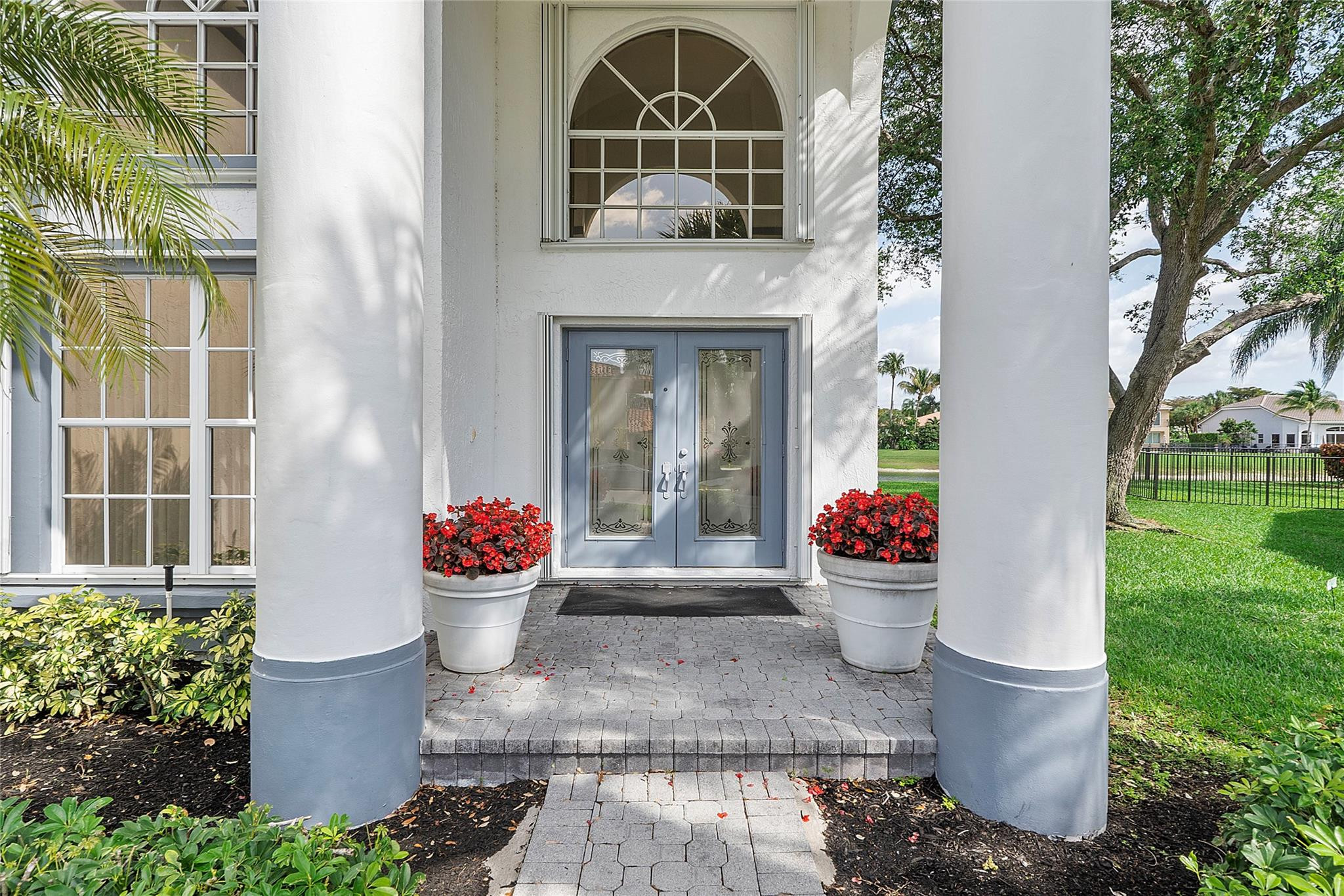 22293 Rushmore Place Boca Raton, FL 33428 - Photo 5 of 59 a front view of a house with a fountain and potted plants