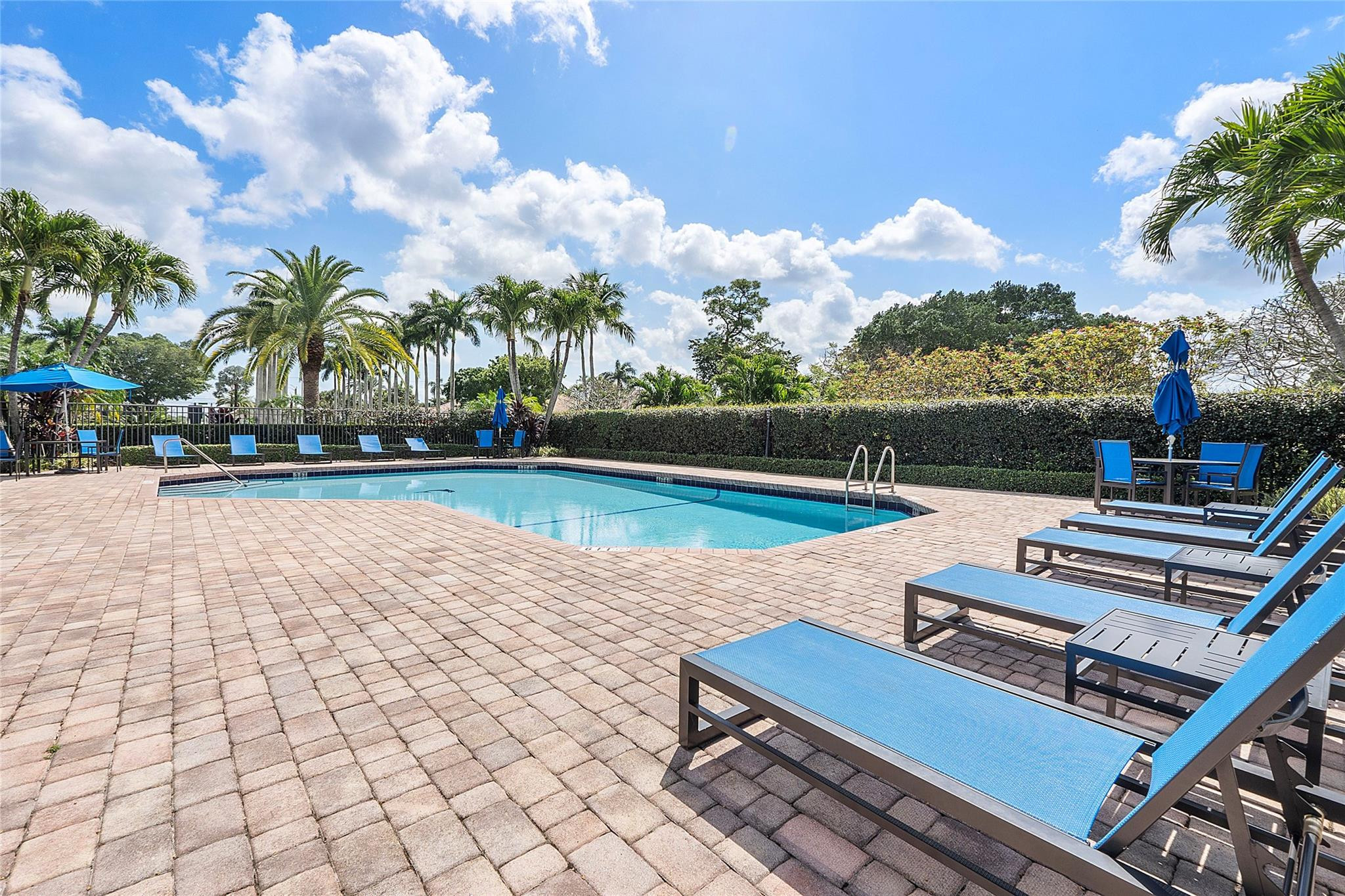 22293 Rushmore Place Boca Raton, FL 33428 - Photo 56 of 59 a view of a swimming pool and lounge chairs