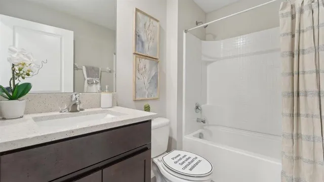 a bathroom with a sink a mirror a bathtub and a shower