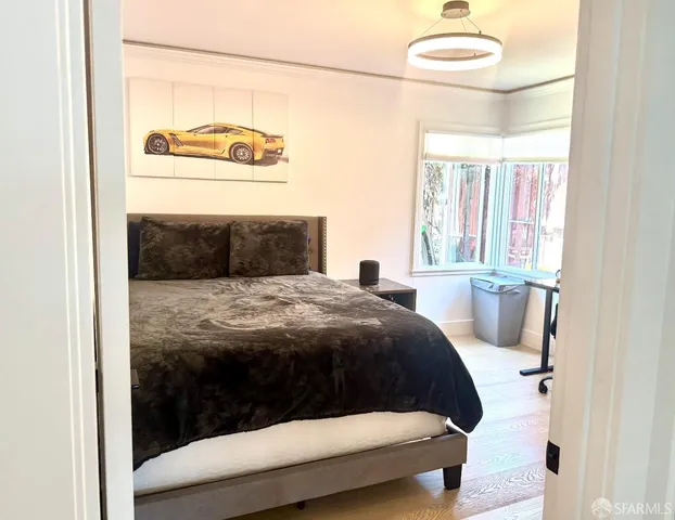 a bedroom with a bed and a painting on the wall