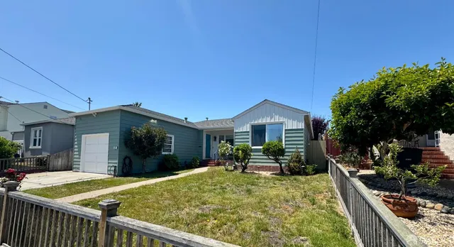 a view of a house with backyard porch and sitting area