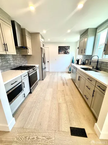 a large kitchen with a stove and a sink