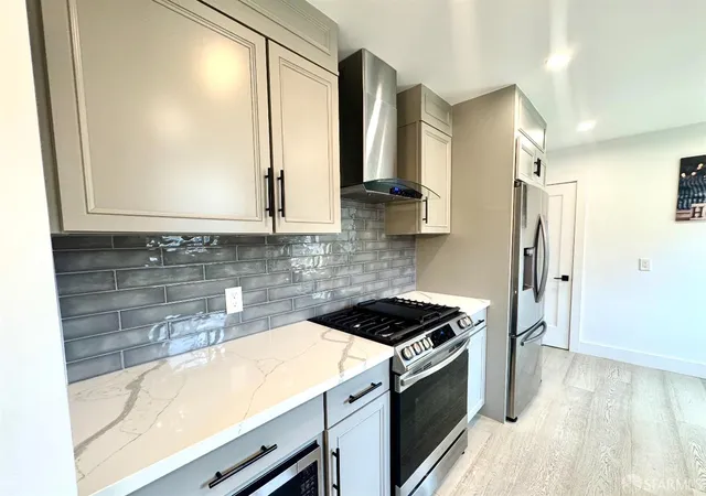 a kitchen with a sink a stove and cabinets