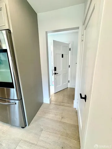 a view of a hallway with wooden floor and entryway