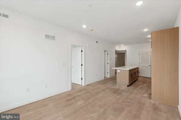 a view of a kitchen with a refrigerator cabinets and wooden floor