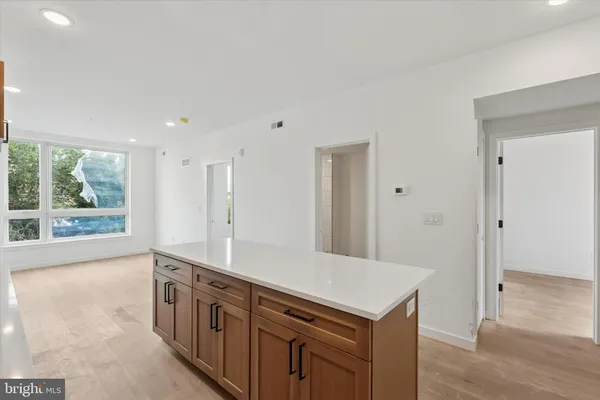 a kitchen with stainless steel appliances granite countertop a sink and a large window