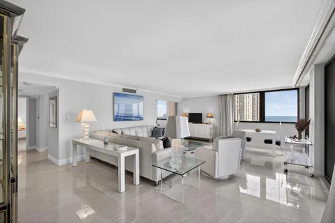 a living room with furniture a rug and a window