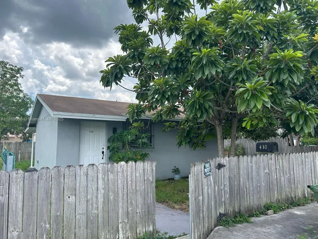a view of a house with a small yard