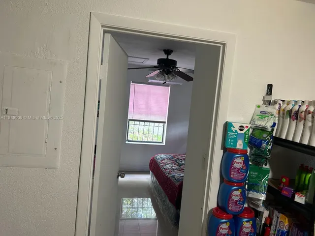 a hallway with furniture and a potted plant