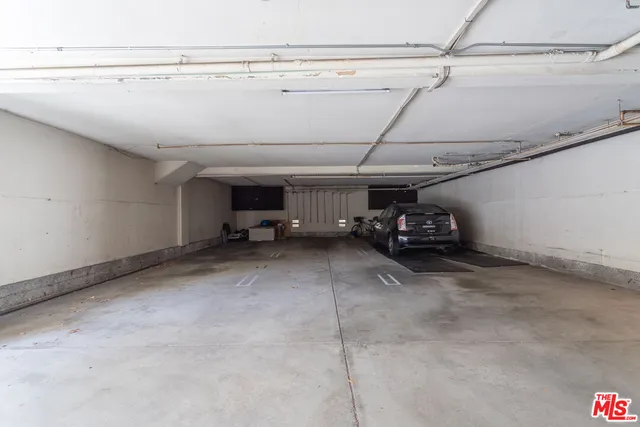 a view of garage with cars