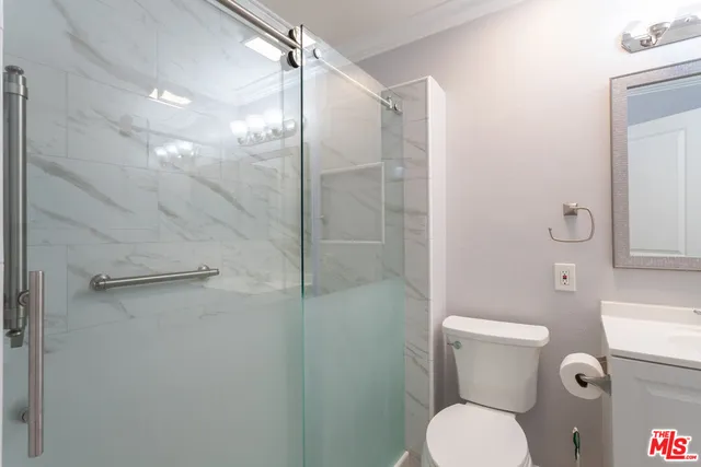 a bathroom with a toilet and a shower