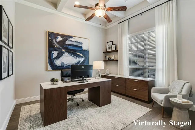 a view of a workspace with furniture and a window