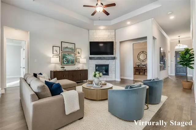 a living room with furniture a flat screen tv and a fireplace