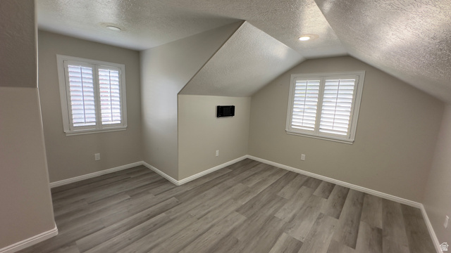 3547 East Golden Eagle Road Eagle Mountain, UT 84005 - Photo 18 of 47 Bonus room with a textured ceiling and light wood-style flooring
