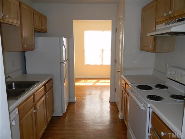 1315 East Lane Street, Unit 2 Raleigh, NC 27610 - Photo 5 of 11 a kitchen with granite countertop a stove and a refrigerator
