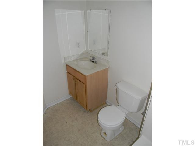 1315 East Lane Street, Unit 2 Raleigh, NC 27610 - Photo 7 of 11 a white toilet sitting next to a bathroom sink