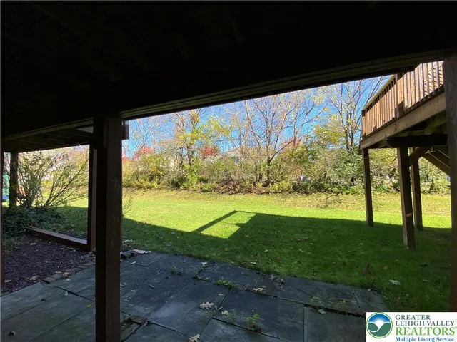 a view of a big room with floor to ceiling windows and yard