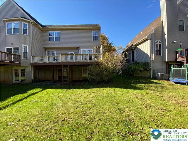 a view of house with yard and swimming pool