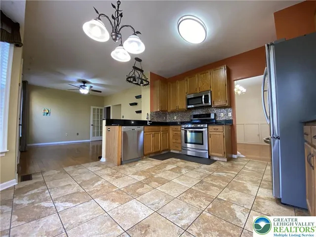 a kitchen with stainless steel appliances granite countertop a stove cabinets and refrigerator