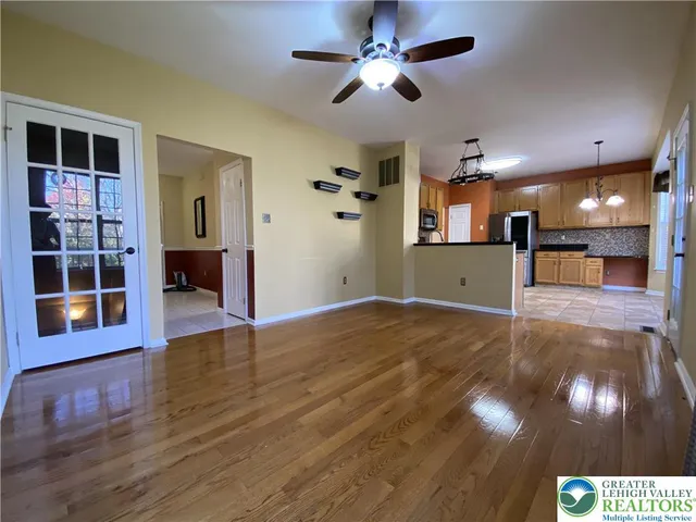 a view of a room with wooden floor and entryway