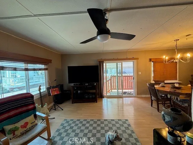 a bed sitting in a bedroom next to a window with a chandelier