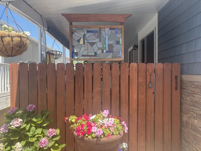 a bunch of flowers with wooden fence