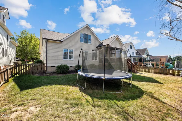 a view of a house with a yard and sitting area