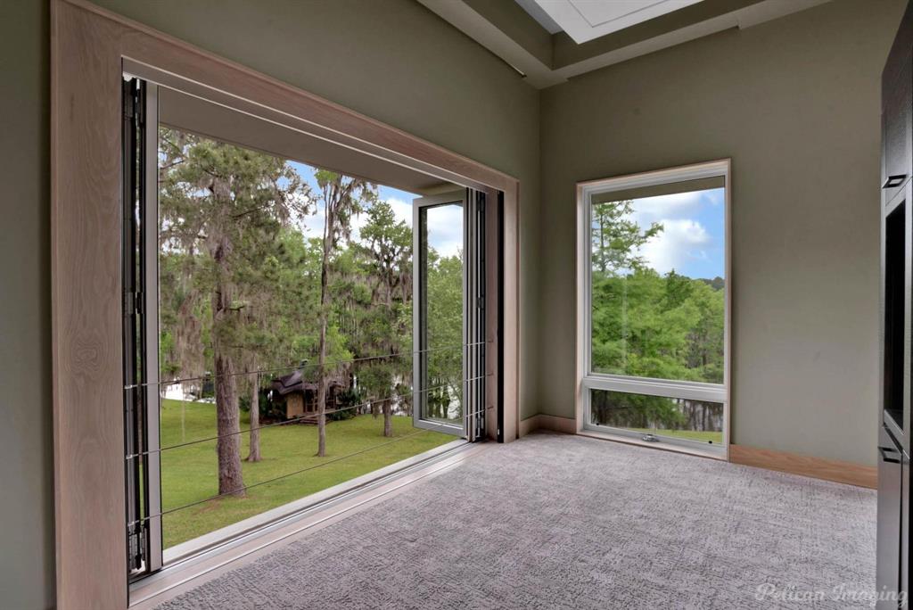 613 Moore Road Elm Grove, LA 71051 - Photo 19 of 39 NanaWall Doors in the primary bedroom allow beautiful views and fresh air