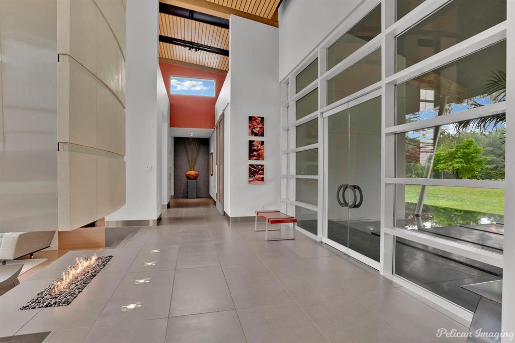613 Moore Road Elm Grove, LA 71051 - Photo 5 of 39 Front foyer with bamboo floors and beautiful natural light and custom hanging fireplace made with limestone from Portugal
