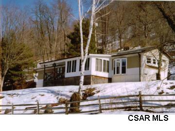 748 Lake Side Road Addison, PA 15411 - Photo 1 of 1 a front view of a house with a yard covered with snow in front of house