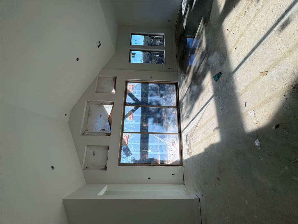 1912 Scenic Hts Lane Georgetown, TX 78628 - Photo 5 of 10 Unfurnished living room featuring high vaulted ceiling, healthy amount of natural light, and concrete floors