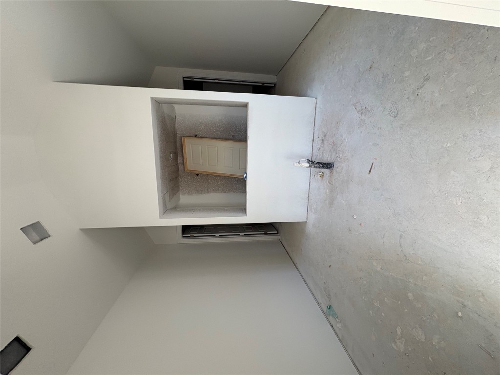 1912 Scenic Hts Lane Georgetown, TX 78628 - Photo 6 of 10 Unfurnished living room featuring vaulted ceiling and unfinished concrete flooring