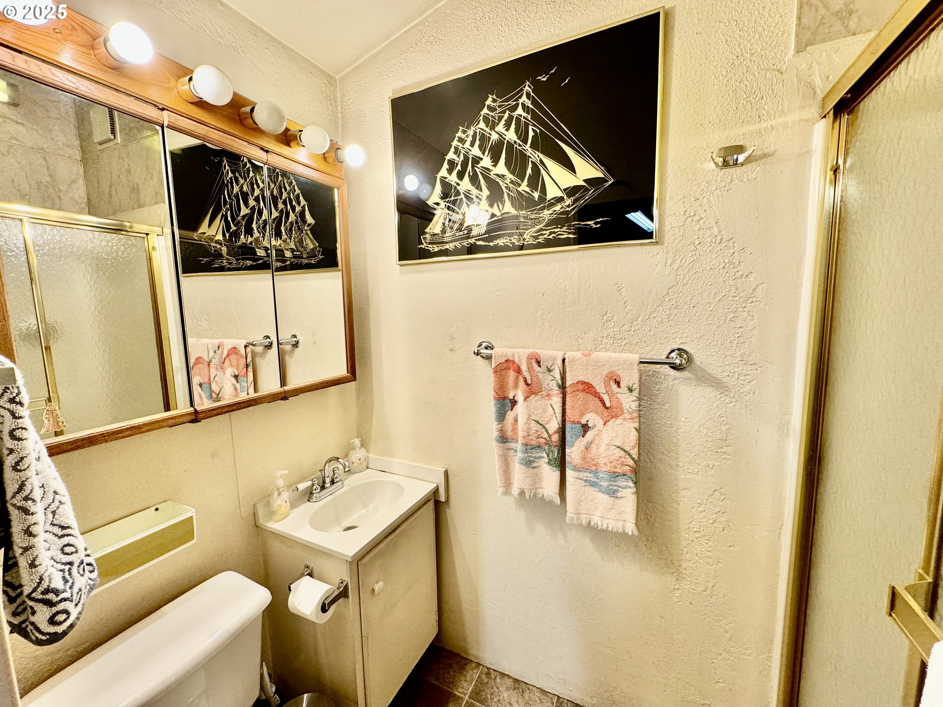 4990 Mitchell Loop Road Florence, OR 97439 - Photo 8 of 37 a bathroom with a sink and mirror with a painting on the wall