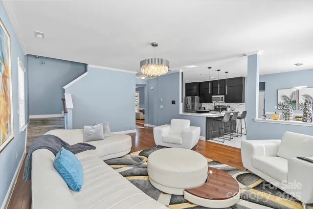 a living room with furniture and a chandelier