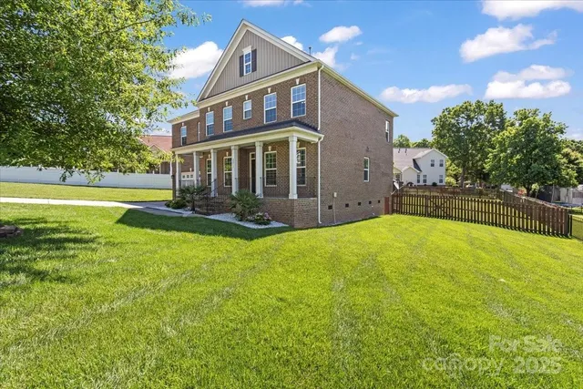 a view of a house with swimming pool and a yard