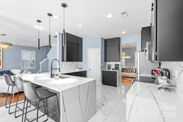 a large kitchen with a table and chairs