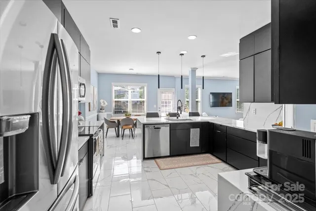 a large kitchen with a large counter top appliances and cabinets