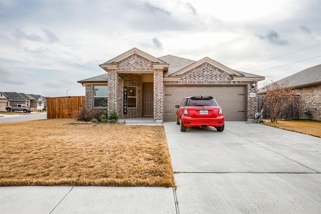 Ranch-style house with brick siding, concrete driveway, a garage, and a shingled roof
