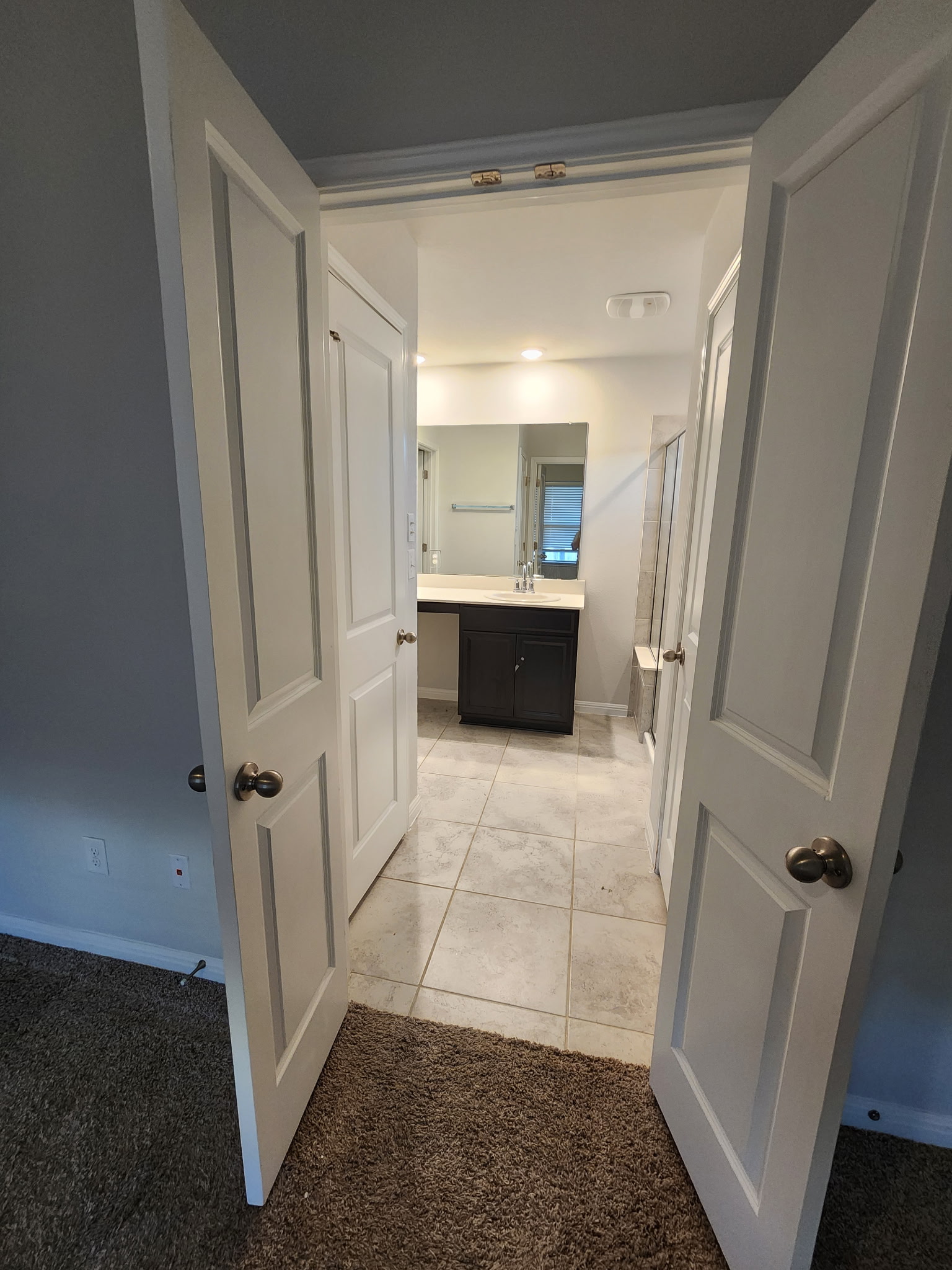 12321 Caldera Way Manor, TX 78653 - Photo 15 of 18 Hall featuring light colored carpet and light tile patterned flooring
