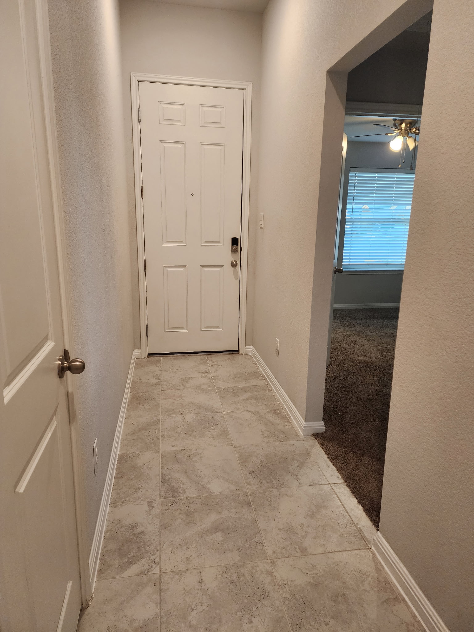 12321 Caldera Way Manor, TX 78653 - Photo 4 of 18 Hallway featuring baseboards and light tile patterned floors