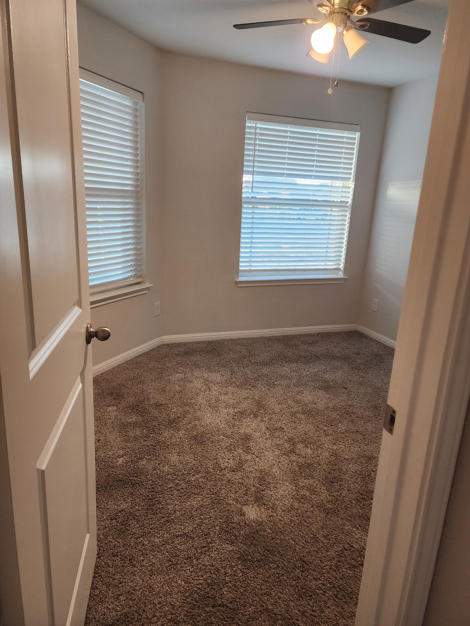 12321 Caldera Way Manor, TX 78653 - Photo 5 of 18 Empty room featuring dark carpet and ceiling fan