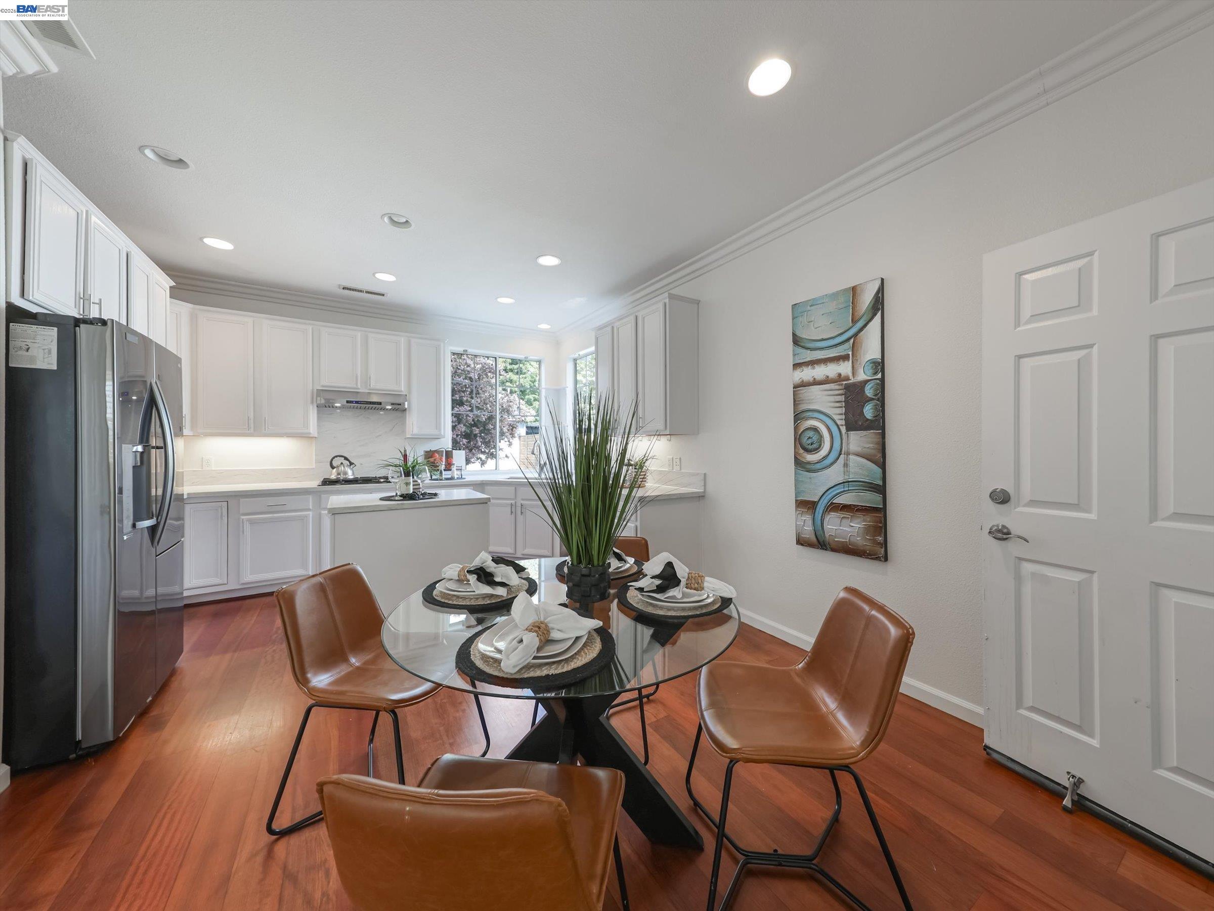 326 I Street Fremont, CA 94536 - Photo 13 of 40 a kitchen with stainless steel appliances a dining table chairs and wooden floor