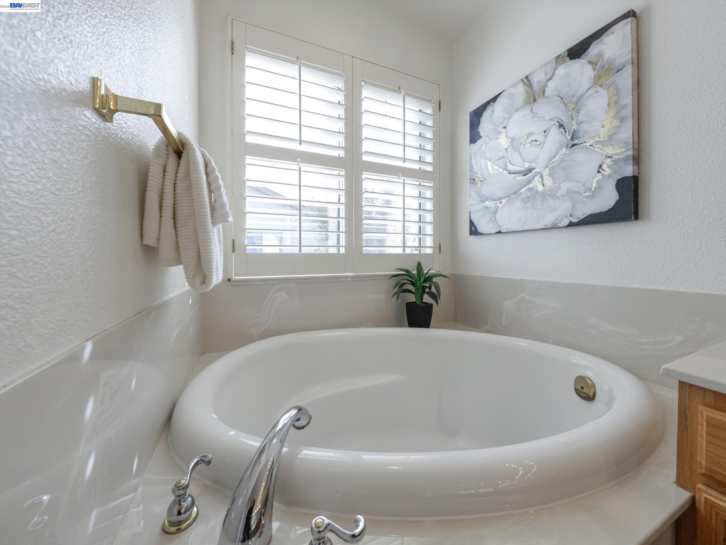 326 I Street Fremont, CA 94536 - Photo 22 of 40 a white bath tub sitting in a bathroom next to a window