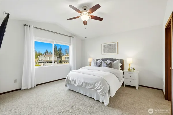 a bedroom with a large bed and a chandelier