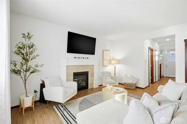 a living room with furniture a fireplace and a flat screen tv